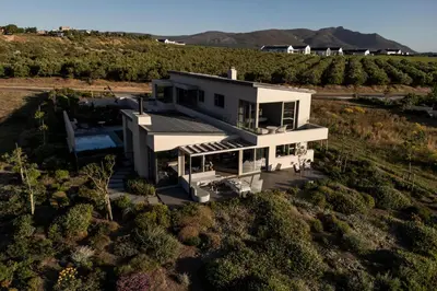 an aerial view of a white house in a field at Benguela Cove - Utopia in Hermanus
