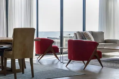 a living room with chairs and a couch and a table at Benguela Cove - Coastal Retreat in Hermanus