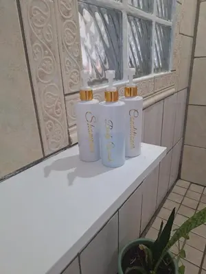 three white cylinders sitting on a shelf in a window at Eucalyptus Cottage in Cape Town