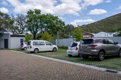a group of three cars parked in a parking lot at Stylish Studio Stellenbosch - Airconditioned in Stellenbosch
