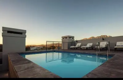 a large swimming pool with chairs on a balcony at Stylish Studio Stellenbosch - Airconditioned in Stellenbosch