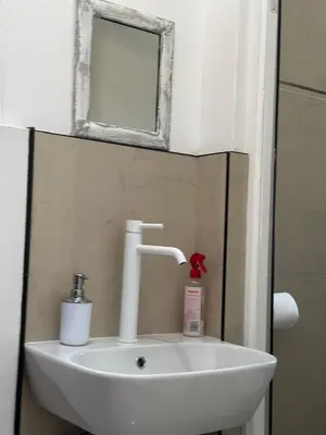 a sink in a bathroom with a mirror and a mirror at MELJAA STAR Guesthouse in Cape Town