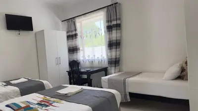 a small bedroom with two beds and a window at MELJAA STAR Guesthouse in Cape Town