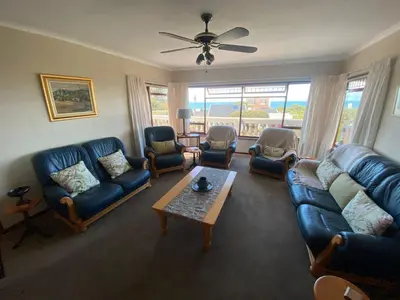a living room with couches and chairs and a table at Somstuis in Hermanus