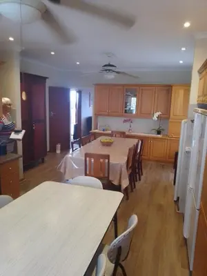 a kitchen with a table and chairs in a kitchen at Somstuis in Hermanus