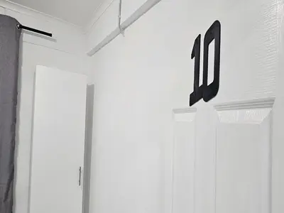 a room with a door with the number on it at Goshen Lodge Fitzroy in Cape Town