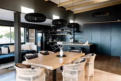 a living room with a wooden table and chairs at Klein-Hangklip in Rooiels