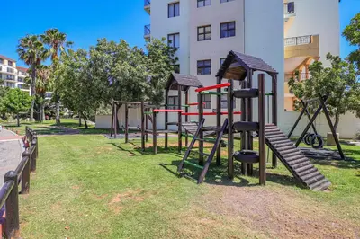 a row of playground equipment in a park at 405 Portofino Eyrie Holiday Apartments in Cape Town