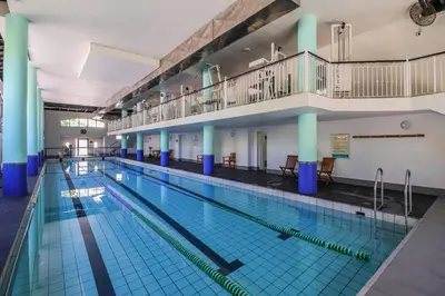 a large indoor swimming pool with blue tiles at 405 Portofino Eyrie Holiday Apartments in Cape Town