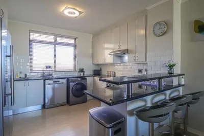a kitchen with a counter and a dishwasher at 405 Portofino Eyrie Holiday Apartments in Cape Town