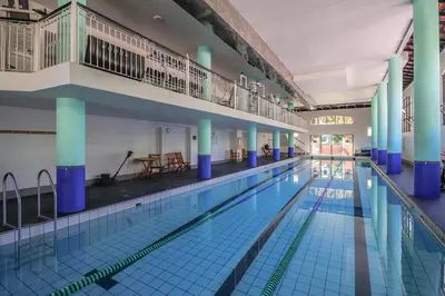 a large swimming pool with blue columns at 102 Palma Eyrie Holiday Apartments in Cape Town