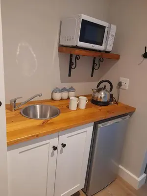 a kitchen counter with a sink and a microwave at Marine View in Hermanus