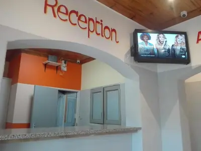 a hospital room with a television on a wall at ALEXIA LODGE & SPA in Cape Town