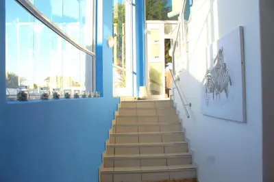 a stairway with blue walls and a blue wall and a staircase with stairsuggest at 7th Wonder Beach Guest House in Cape Town