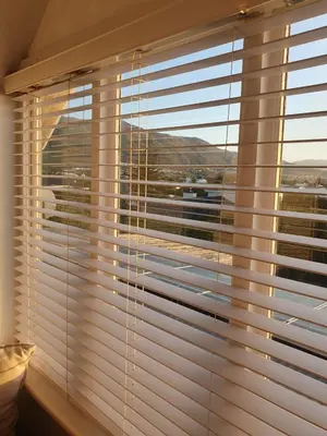 a window with blinds in a room with a view at Vermont Lofts in Hermanus