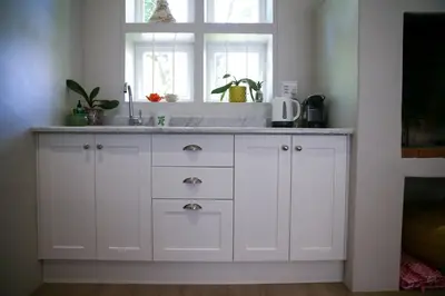 a kitchen counter with a sink and a window at Ivy House - Super Spacious Spot- Somerset West in Somerset West