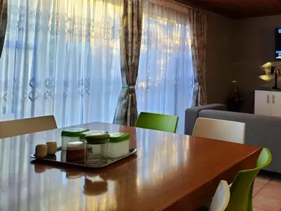 a dining room table with a tray of food on it at Step-by-Step Self-Catering and B&B in Bellville