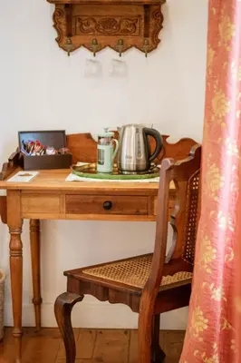a wooden table with a tea kettle on top of it at Kolonie's Tuin in Stellenbosch