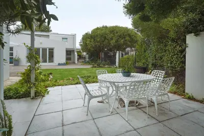 a table and chairs sitting on a patio at Tuis en Tevrede - 1 Bedroom Flat in Hermanus