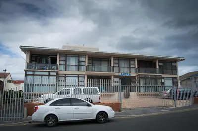 a white car parked in front of a building at 5 Lantra in Strand