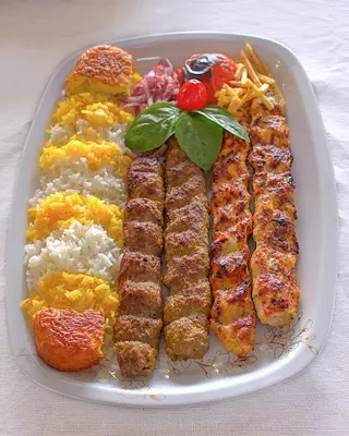 a plate of food with meat and rice and vegetables at Ocean Vibes in Cape Town