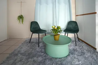 a room with two chairs and a table with a plant at Ocean Vibes in Cape Town