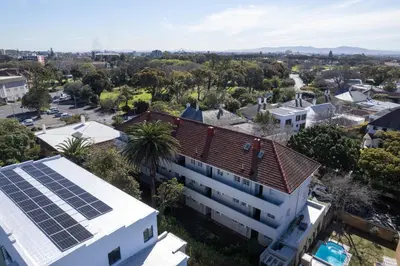 an overhead view of a building with solar panels on the roof at Secure and Modern 2Bed Apartment in Cape Towns Charming Rondebosch in Cape Town