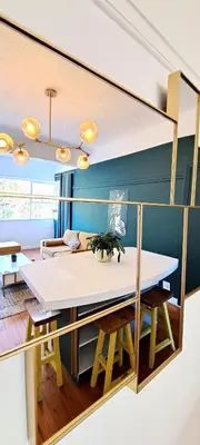 a living room with a table and a couch at Secure and Modern 2Bed Apartment in Cape Towns Charming Rondebosch in Cape Town