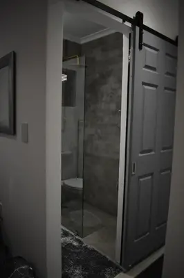 a glass door leading to a bathroom with a toilet at Langbeentjie Inn Two Point O in Cape Town