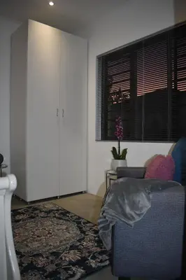 a living room with a couch and a window at Langbeentjie Inn Two Point O in Cape Town