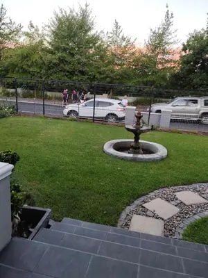 a park with a fountain in the grass at Ladamon 3 in Paarl