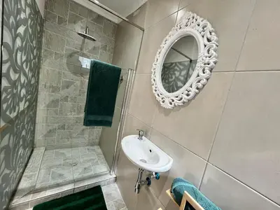 a bathroom with a sink and a mirror at Ladamon 3 in Paarl