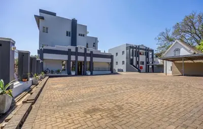 an empty parking lot in front of a building at Kaneel Suiker - Paarl - Self Catering Apartment in Paarl