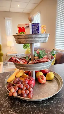 a three tiered display of fruits and vegetables on a counter at The Lazy Expat - Paarl - Self Catering Apartment in Paarl