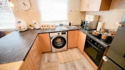 a kitchen with a washing machine in a kitchen at The Lazy Expat - Paarl - Self Catering Apartment in Paarl