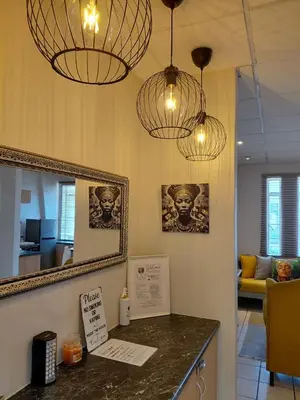 a room with a counter with two lights and a mirror at The Skinny Expat - Paarl - Self Catering Apartment in Paarl