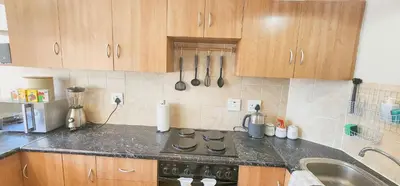 a kitchen with a sink and a stove top oven at The Tipsy Expat - Paarl - Self Catering Apartment in Paarl