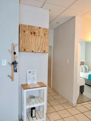 a room with a table and a bed at The Tipsy Expat - Paarl - Self Catering Apartment in Paarl