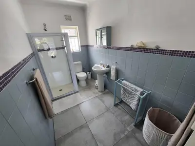 a bathroom with a shower and a toilet and a sink at A spacious Haven near Bloubergstrand beach in Cape Town