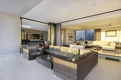 a large living room with couches and a living room at Baronetcy Kings Villa in Plattekloof