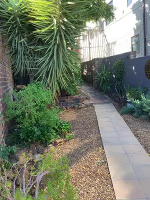 a garden with a stone walkway and plants at Cozy Garden apartment with amazing view in Cape Town
