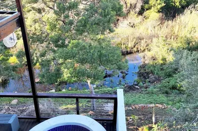 a view of a river from a balcony at 4 Bed Selfcatering River Tree House overlooking the Onrus river in Hermanus