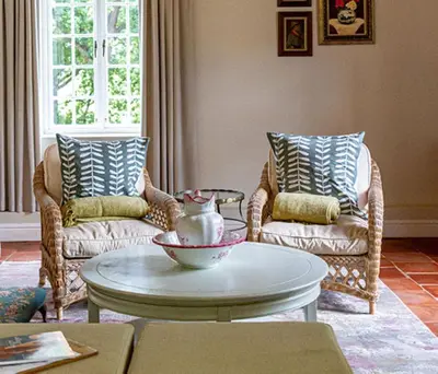 a living room with two chairs and a coffee table at Plaisir Estate Accommodation in Simondium
