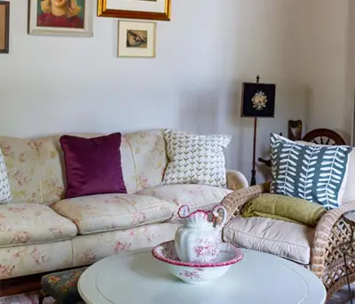a living room with a couch and a table at Plaisir Estate Accommodation in Simondium