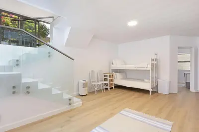 a white room with a staircase and a bedroom at Suidersee-Voelklip in Hermanus