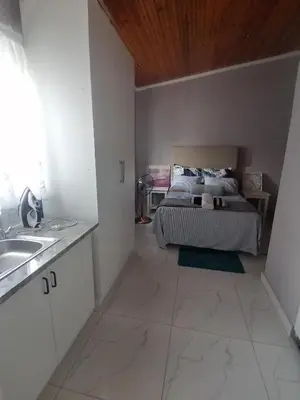 a bedroom with a bed and a sink in it at Mila Lodge 1 in Cape Town
