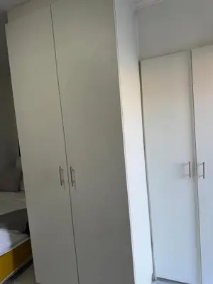 a pair of white cabinets in a room at Mila Lodge 2 in Cape Town