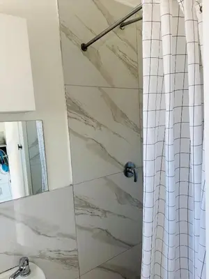 a bathroom with a shower with a shower curtain at Mila Lodge 2 in Cape Town