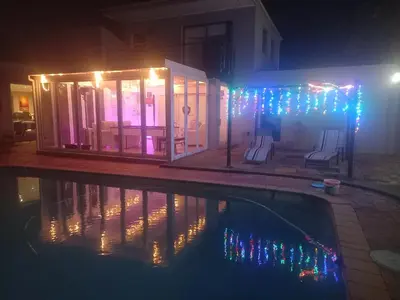 a house with a swimming pool at night at 51 On Vlei in Cape Town