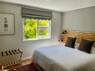 a bedroom with a large bed and a window at Stellenbosch Serenity in Stellenbosch